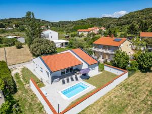 an aerial view of a house with a swimming pool at More i Sol Rab Pool House in Rab