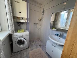 a bathroom with a washing machine and a sink at Ferienhaus Gansbach in Gansbach +69 photos