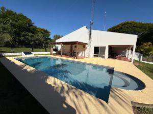 a swimming pool in front of a house at Casa Lago in Santa Ana +20 photos