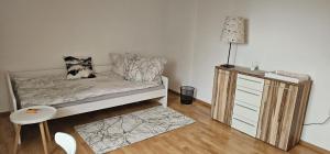 a room with a bed and a dresser with a lamp at stilvolles Apartment für 4 Personen in Ulmerfeld in Ulmerfeld