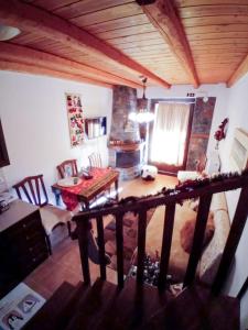 a living room with a table and a room with a fireplace at Kaimak Whisper in Palaios Agios Athanasios +10 photos
