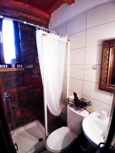 a bathroom with a shower and a toilet and a sink at Kaimak Whisper in Palaios Agios Athanasios