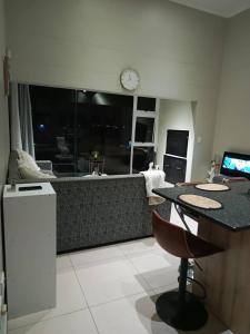 a living room with a couch and a table at African Nest in Windhoek