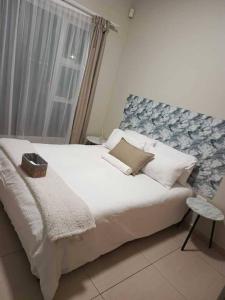 a bedroom with a large bed and a window at African Nest in Windhoek