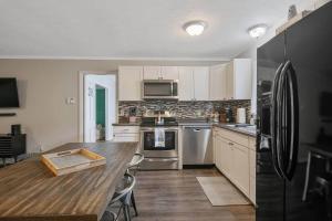 费耶特维尔Home Base的配有木桌和冰箱的厨房