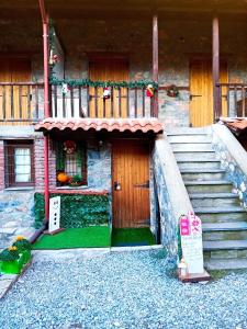 a house with a door and stairs in front of it at Kaimak Whisper in Palaios Agios Athanasios