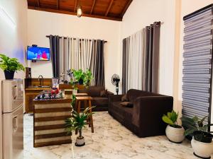 a living room with a couch and a table at Sunset Villa in Dickwella