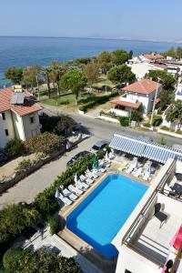 vista aerea su una piscina con sedie e sull'oceano di Çidihan HOTEL a Kusadası