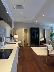 a kitchen with a counter and a living room at DA Hotel Apartments in Gothenburg