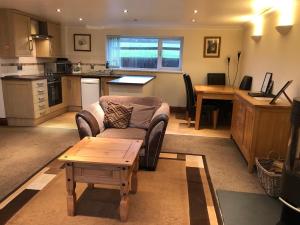 a living room with a couch and a table at The Annexe at the Cedars in South Brent
