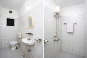 a white bathroom with a toilet and a sink at Hotel #Blue Moon# Front Of Bhubaneswar Railway Station in Bhubaneshwar