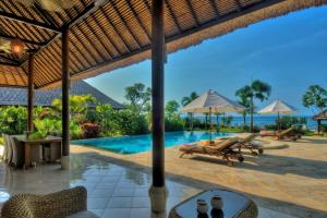 een afbeelding van een resort met een zwembad bij Beachfront Villa Nirwana with Private Jacuzzi in Pengastulan