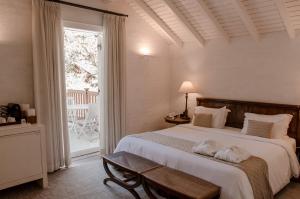 Un dormitorio con una cama grande y un balcón. en Roots Resort, en Monte Verde 103 fotos más