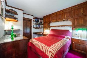 Schlafzimmer mit einem Bett, einem Schreibtisch und Schränken in der Unterkunft tHE Courmaison - Courmayeur in Courmayeur