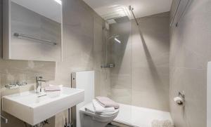 a bathroom with a sink and a toilet and a shower at Figaro in Leukerbad +20 photos