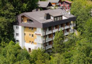 an aerial view of a hotel on a hill with trees at Figaro in Leukerbad