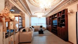 a living room with a couch and a television at 3 bedroom Nijma large authentic Moroccan apartment in Tangier