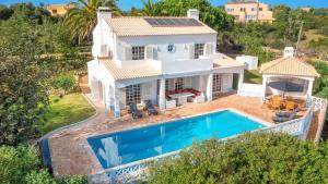 an aerial view of a villa with a swimming pool at Spacious Villa Swimming Pool by HostWise in Lagoa