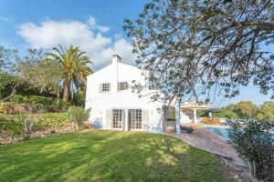 an exterior view of a white house with a pool at Spacious Villa Swimming Pool by HostWise in Lagoa