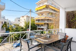 a balcony with a table and chairs and a building at Andromaches by Verde Apartments in Athens