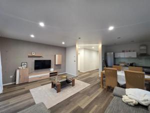 a living room with a couch and a dining room at NEU! Modernes Wohnen Bad Berleburg in Meckhausen