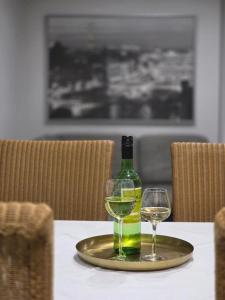 a bottle of wine and two glasses on a table at NEU! Modernes Wohnen Bad Berleburg in Meckhausen +10 photos