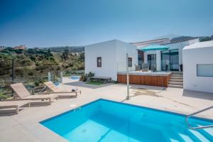 a villa with a swimming pool and a house at Suite Risco 2 in La Guancha