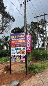 Et logo, certifikat, skilt eller en pris der bliver vist frem på Prakruthi home stay