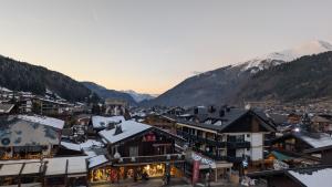 a town in the mountains with snow on the roofs at Edelweiss Lodge in Morzine