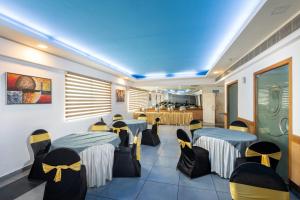 a restaurant with tables and chairs in a room at The Senate Hotel By Addon Group in Cochin
