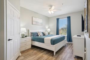 a bedroom with a bed and a window at 3BR Windsor Hills Condo Water Park and Skeeball Near Disney No Resort Fees in Orlando +27 photos