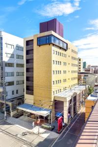 a large building with awning in front of it at Sun Palace Hotel in Shizuoka