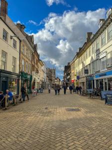 a city street with people walking down the street at Garden House Stamford in Stamford