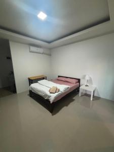 a bedroom with a bed and a table in it at Little Bailan Retreat - Garden & River Side in Ban Bang Bao