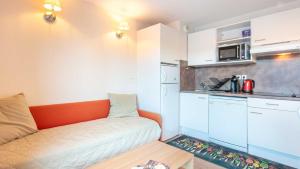 a small kitchen with a couch and a microwave at Les Balcons d Aix N701 2P6 in Les Déserts
