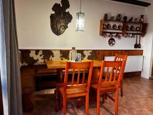 een eetkamer met een houten tafel en stoelen bij Chata v Kamenném Přívozu in Kamenný Přívoz