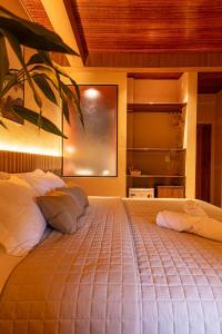 a bedroom with a large bed with white pillows at Hotel Ilha do Marajó by Unna in Soure +108 photos