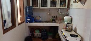 a small kitchen with a sink and a stove at Villa Montana Batulayang in Sampal 2