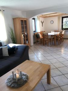a living room with a couch and a table at Ferienwohnung Ottenzeller Haisl in Arrach