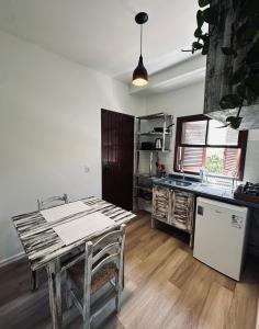 a kitchen with a wooden table and a refrigerator at Ar do Mar in Florianópolis