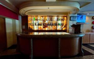 a bar with a lot of bottles of alcohol at Hot Plaza Camarones - Love Hotel - Solo Adultos in Mexico City +5 photos