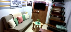 a living room with a couch and a tv at Apartment Cabin-Style in Belgrade