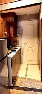 a kitchen with a white door and a stove at Apartment Cabin-Style in Belgrade +8 photos