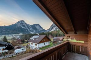 a view from the balcony of a house with mountains at StoderLodge - Alpine Garden Residence - by myNests in Gröbming