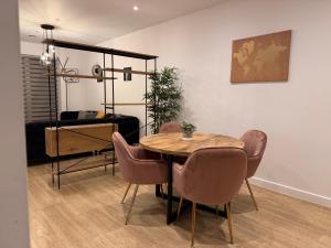 a dining room with a table and chairs and a bedroom at HRF Barking Apartments in Barking