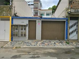 a house with two garage doors in a city at Apartamentos - Repouso do Guerreiro in Itabuna
