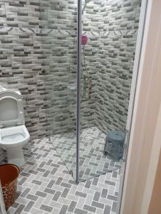 a bathroom with a shower with a toilet at Flat Al farabi in Agadir +30 photos