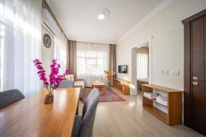 a living room with a wooden table and a living room with a couch at Feyza Apart in Istanbul