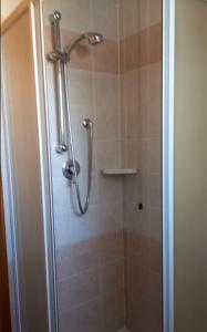 una doccia in un bagno con una porta in vetro di Villetta Serenity presso Residence ai Salici a Caorle