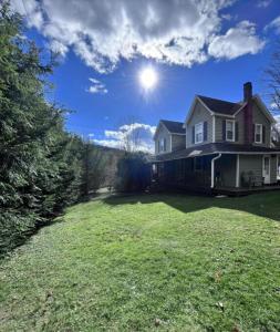 una casa con un grande cortile con il sole nel cielo di Charming Four Bedroom House a Tannersville